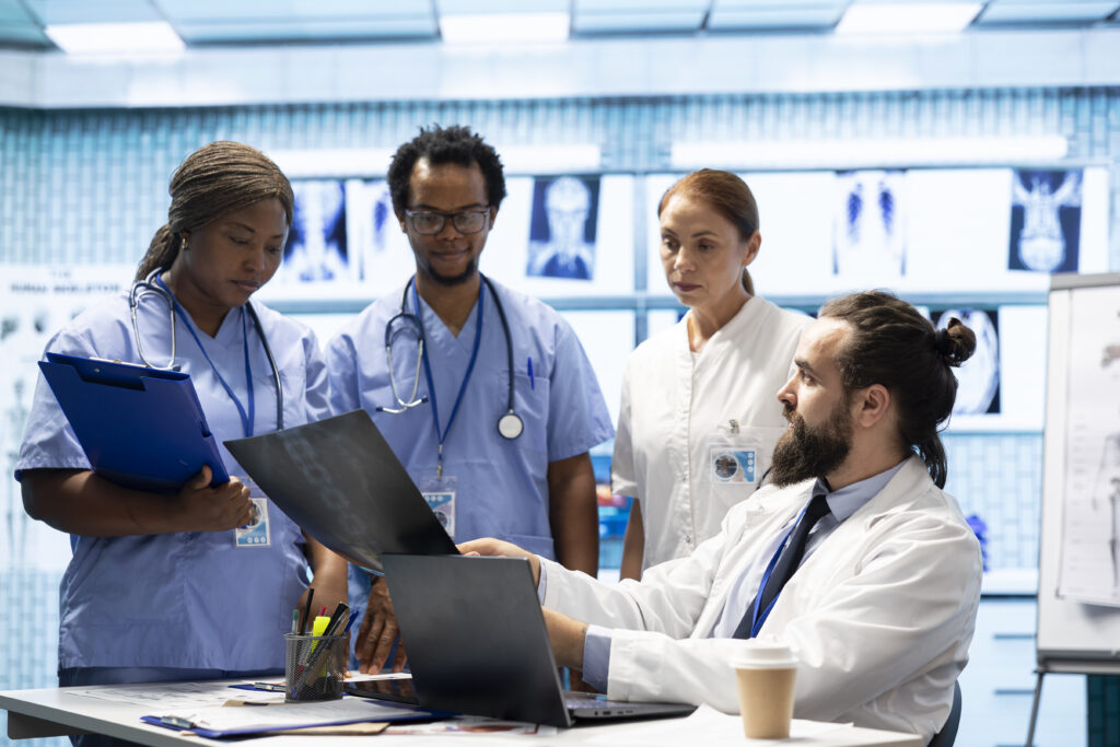 group of healthcare workers analyzing diagnostic data and planning treatment